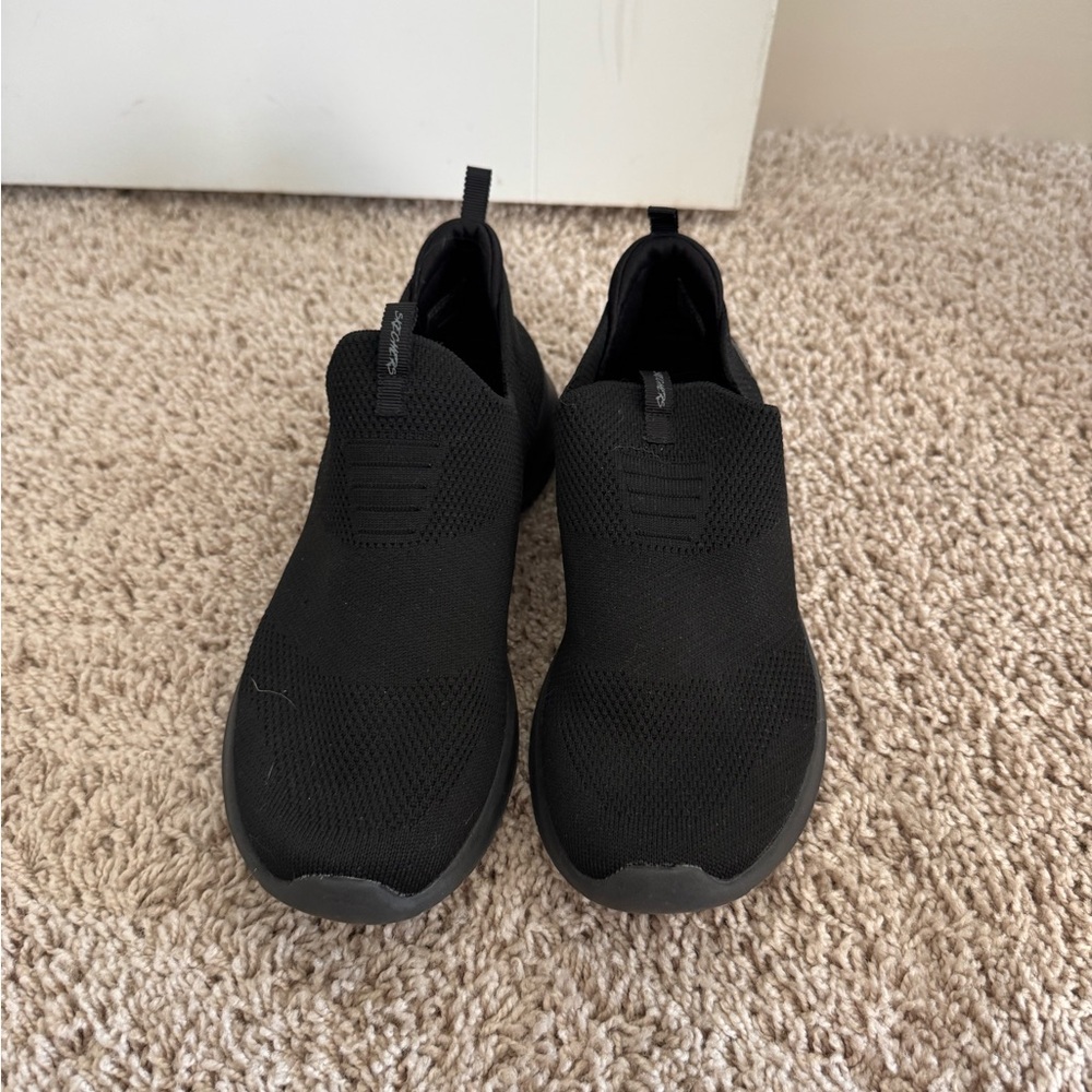 Women’s black Skecher slip ons